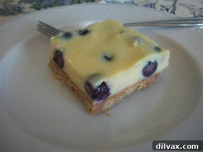 Thirty-Ninth Wicked Good Wednesday 4 Vibrant lemon blueberry bars with a crumbly topping, displayed on a serving plate