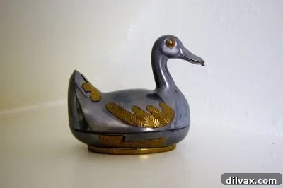 A pewter duck figurine, a sentimental object that brings back cherished memories.