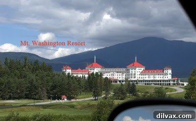 A calm lake reflecting the surrounding trees and sky, showcasing New England's natural beauty.