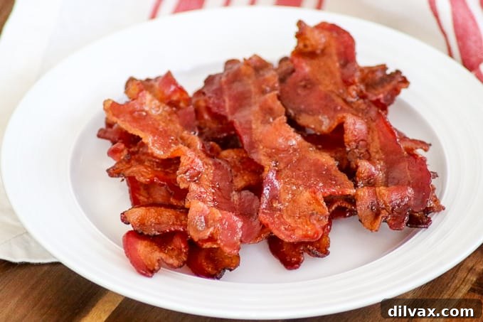 Perfectly cooked bacon on a plate, crispy and delicious every time.