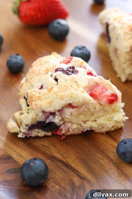Mixed Berry Scones on Wooden Tray Freshly baked Mixed Berry Scones arranged on a rustic wooden tray, ready to be enjoyed.