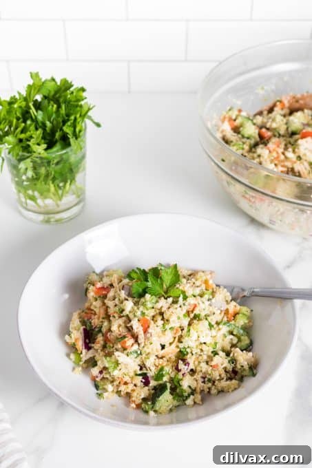 A vibrant bowl of Greek Quinoa Chicken Salad ready to be served, highlighting the fresh ingredients.