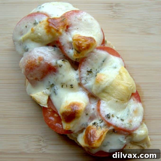 Artichoke Tomato Chicken: A Fast & Flavorful Meal Succulent chicken breasts adorned with fresh herbs, ripe tomatoes, tender artichoke hearts, and melted cheese, cooked to perfection in under 30 minutes.