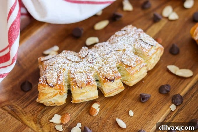 Chocolate Bear Claws - sliced almonds, powdered sugar cover a puff pastry filled with semi-sweet chocolate chips. A delicious breakfast or brunch treat.