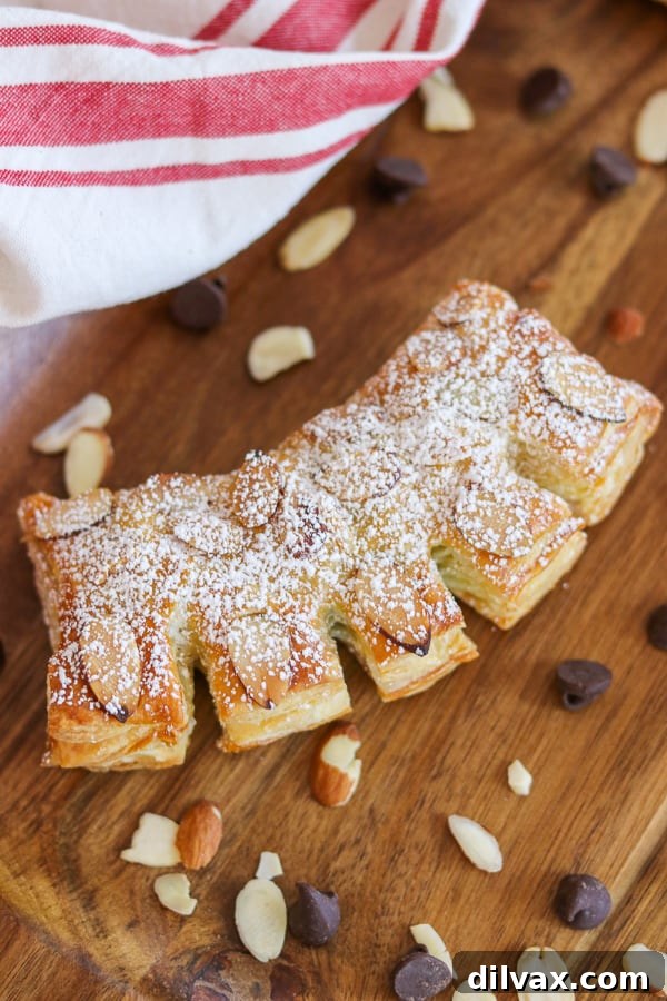 To make Chocolate Bear Claws, fill puff pastry with semi-sweet chocolate chips, bake and then top with sliced almonds and powdered sugar. A perfect breakfast treat.