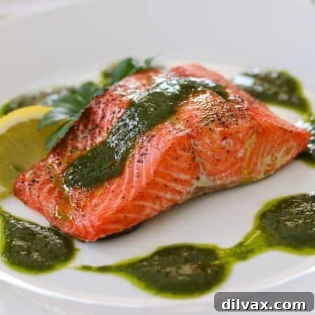 A salmon fillet topped with a chimichurri sauce.