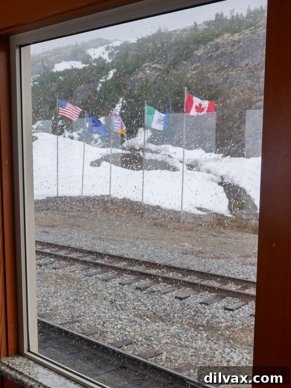 Flags at the US / Canada border on the White Pass Scenic Railway tour.