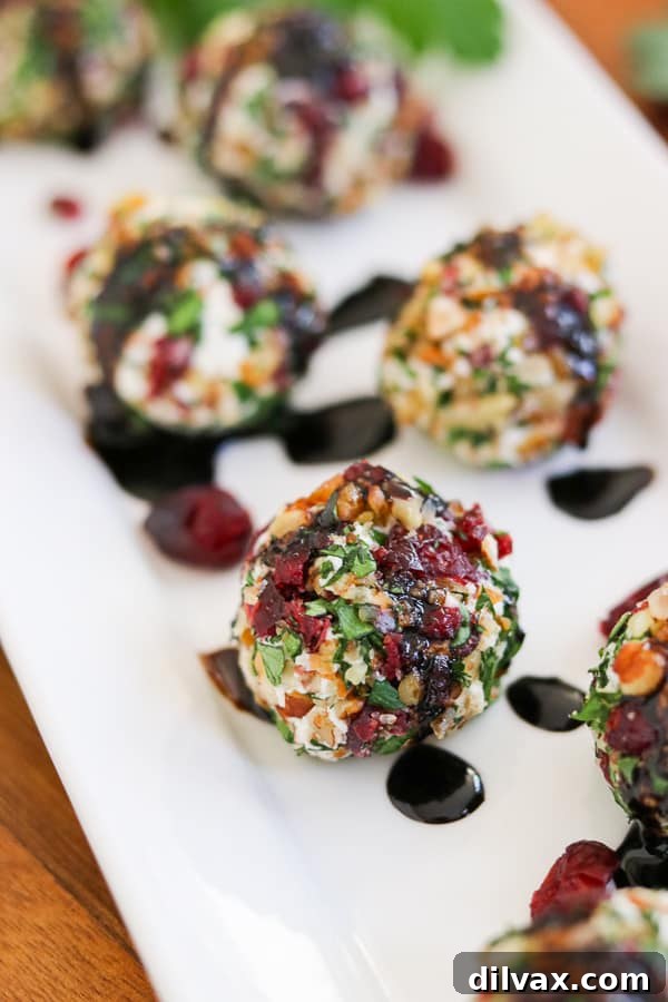 Need the perfect appetizer for a party? Make these Cranberry Pecan Goat Cheese Bites. They're also rolled in fresh parsley.