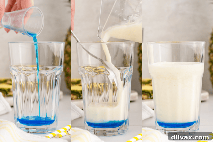 Azure Abyss Elixir 6 Pouring the Pina Colada mixture over Blue Curaçao using a spoon to create layers