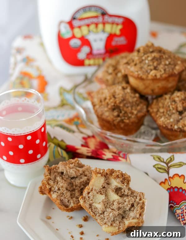 A glass of milk and an Apple Streusel Muffin on a plate. A refreshing glass of Shamrock Farms Organic Milk perfectly accompanies a delicious Apple Streusel Muffin on a wooden surface.