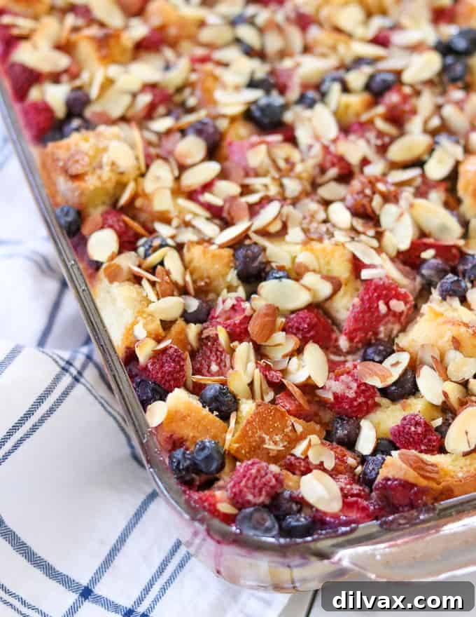 A large pan of freshly baked Almond Berry French Toast Casserole, golden brown and inviting, straight from the oven.