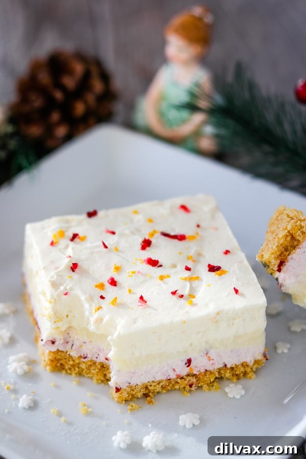 Square slice of Cranberry Orange Dream Bars, showcasing the beautiful layers of this festive dessert.