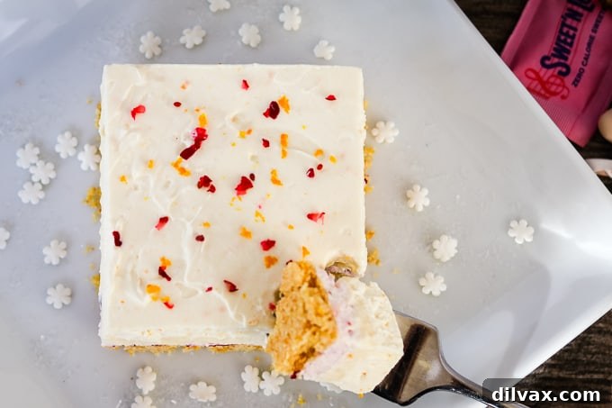 Top view of Cranberry Orange Dream Bars, highlighting the fresh cranberry garnish.