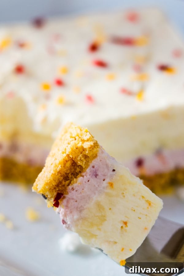 Close up of a Cranberry Orange Dream Bar, emphasizing the layers and a perfect bite.