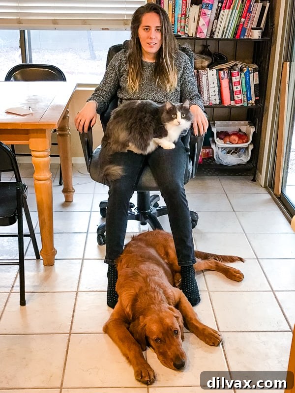 Furry Friend Friday Family 7 Logan the Golden Retriever and Winnie the cat comfortably sharing space with Alex, highlighting the harmonious pet and family dynamic.