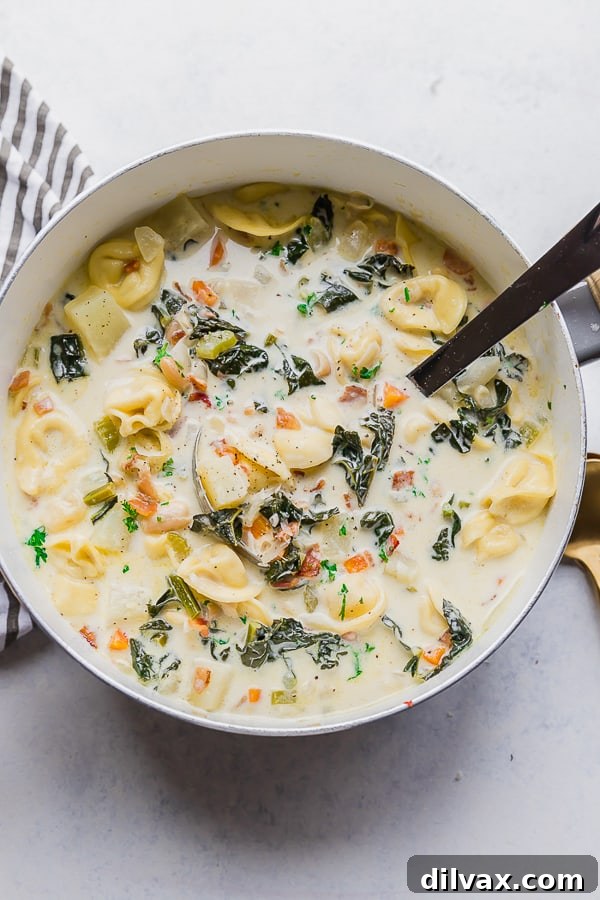 One Pot Bacon and Tortellini Zuppa Toscana. A large pot filled with One Pot Bacon and Tortellini Zuppa Toscana, ready to be served.
