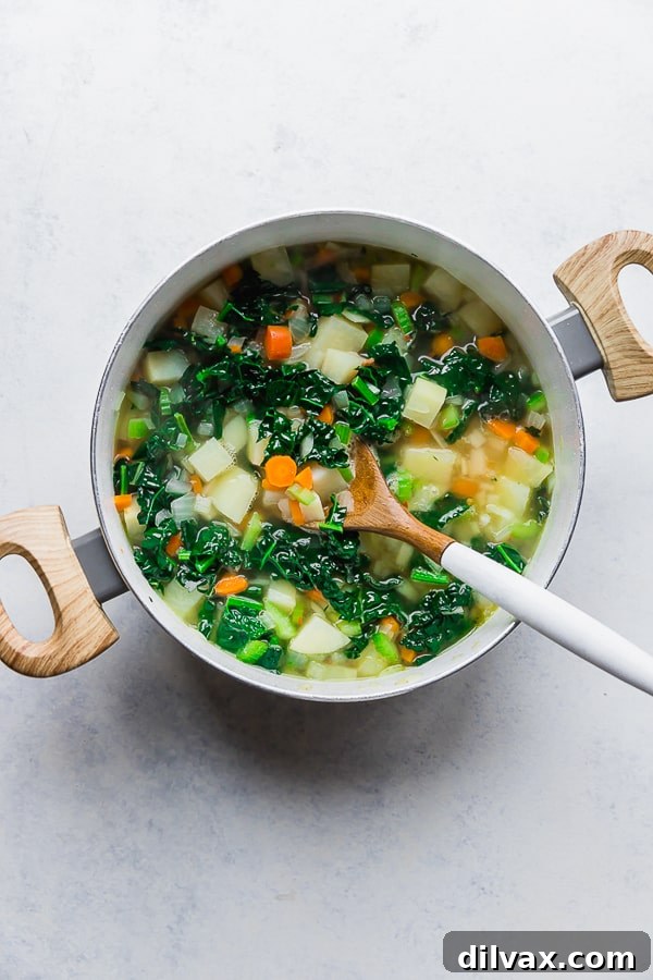 Vegetables and broth for One Pot Bacon and Tortellini Zuppa Toscana. Vegetables simmering with broth in a pot, creating a flavorful base for the Zuppa Toscana.