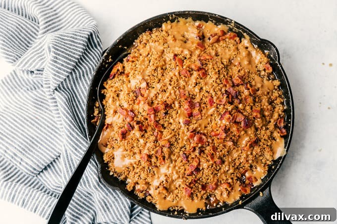 Sweet and Salty Bacon Caramel Apple Crisp 2 Bacon Caramel Apple Crisp with Pure Farmland Bacon in a cast iron skillet, showcasing a perfect balance of savory and sweet.