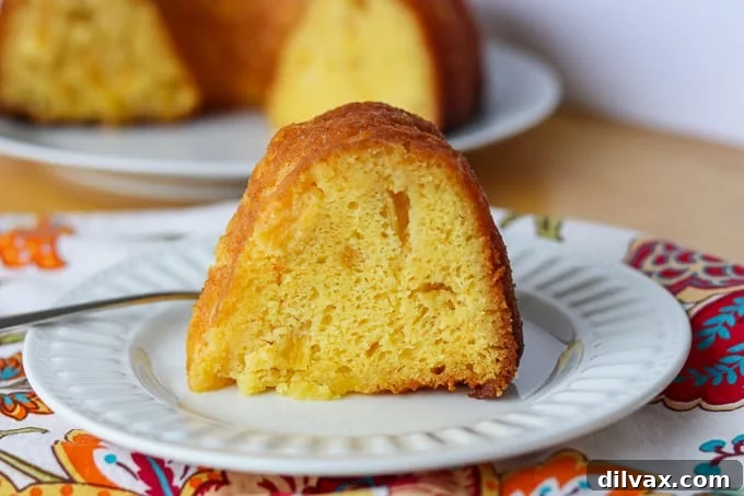 Side shot of Pineapple Rum Cake on a plate. Side shot of Pineapple Rum Cake on a plate.