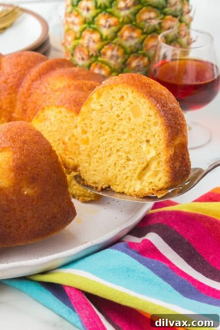 A whole Pineapple Rum Cake with a dusting of powdered sugar.