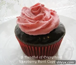 Delicious Raspberry Devil Cupcakes, garnished with fresh raspberries and cream.
