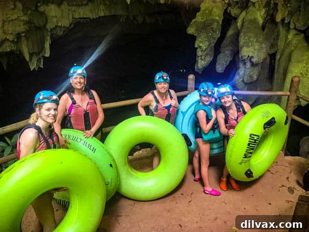 Cave Tubing in Belize A group of people enjoying cave tubing in a lush, natural setting in Belize.