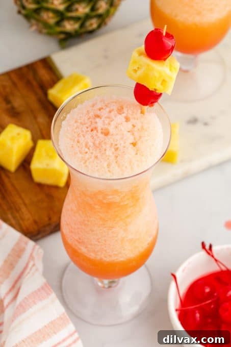 Paradise Blend 7 Close-up shot of the vibrant top of a tropical cocktail, showing the colorful layers and garnishes.