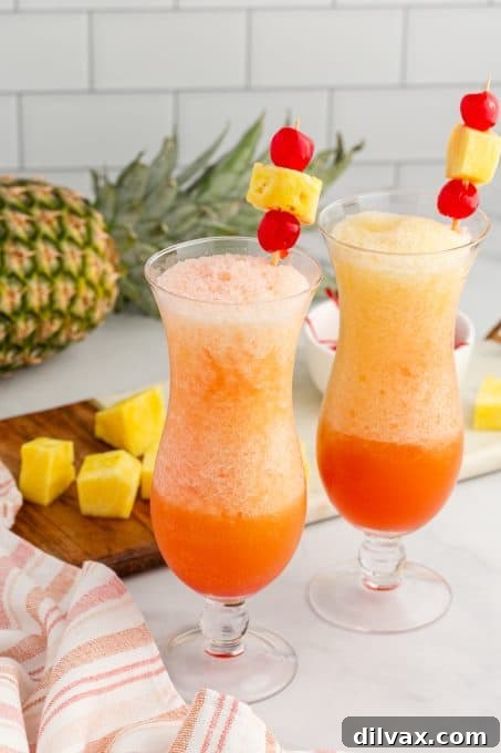 Paradise Blend 8 A vibrant frozen cocktail, rich with rum, orange and pineapple juices, and a distinct layer of grenadine at the bottom.