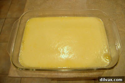 Pouring the lemon filling over the cooled crust.