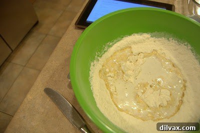 Preparing the crust mixture with flour, powdered sugar, and melted butter.