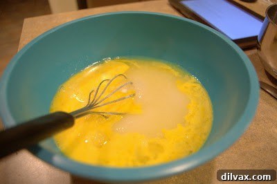 Whisking eggs, sugar, and lemon juice for the filling.