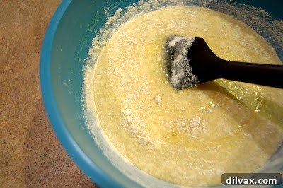 Adding dry ingredients to the lemon filling mixture.