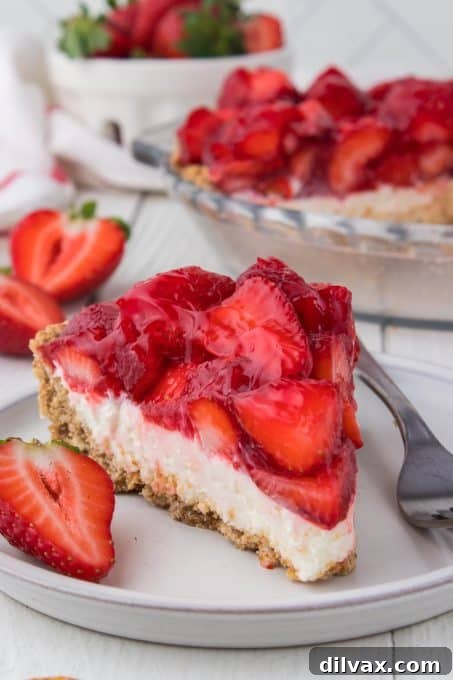 A beautifully presented whole Strawberry Pretzel Pie on a serving plate, ready to be sliced.
