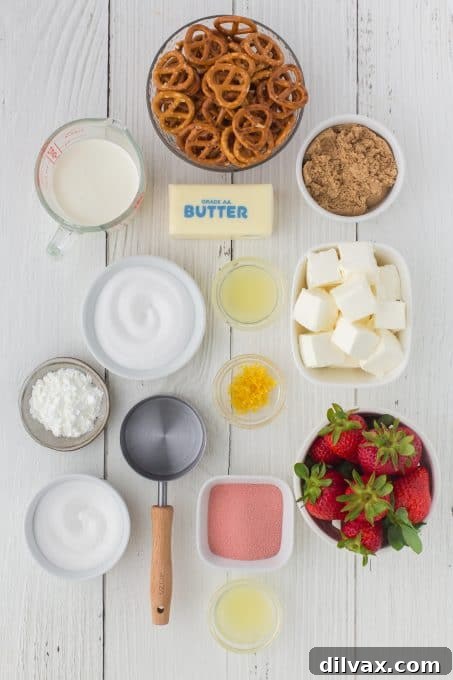 All the fresh ingredients for Strawberry Pretzel Pie laid out on a kitchen counter, including pretzels, strawberries, and cream cheese.