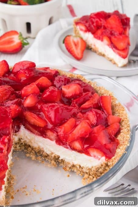A close-up side view of Strawberry Pretzel Pie, clearly showing the distinct layers of pretzel crust, cheesecake, and strawberry topping.