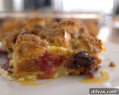 A comforting close-up of a slice of Blueberry French Toast Bake, ready to be enjoyed with family.