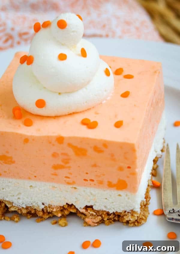 Orange Cloud Nine Bars 13 A single slice of Orange Creamsicle Dream Bars on a plate, showing all layers