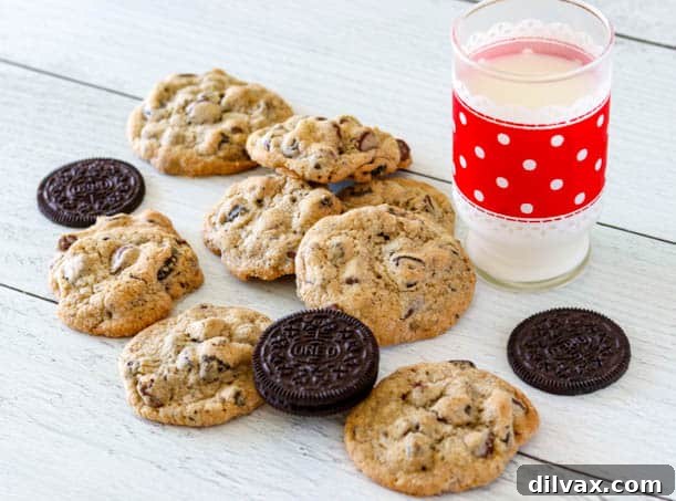 Oreo Chocolate Chip Cookies and a glass of milk. Freshly baked Oreo Chocolate Chip Cookies next to a refreshing glass of milk, inviting a perfect dunk.