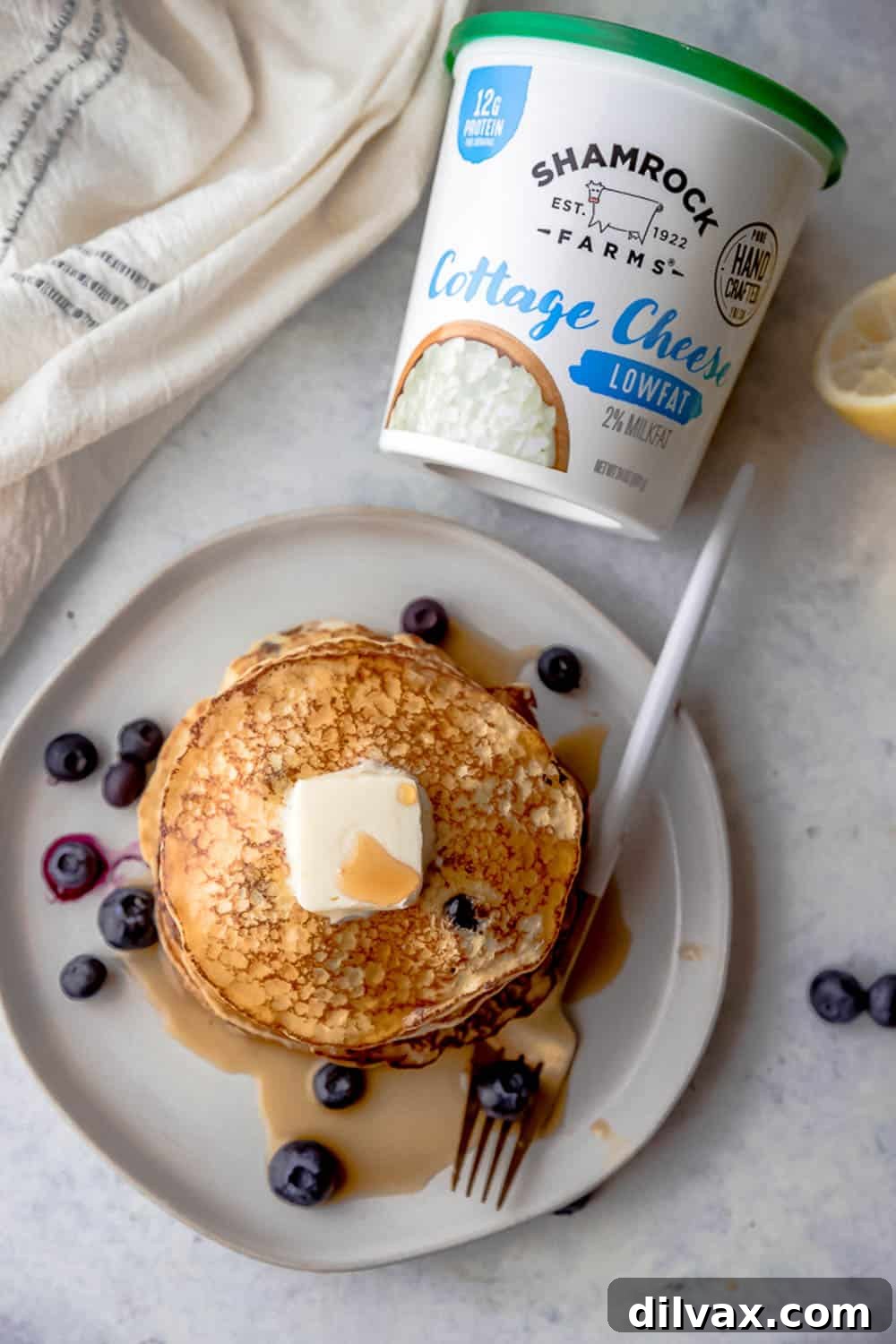 Protein-Packed Cottage Cheese Pancakes Close-up of freshly made Lemon Blueberry Cottage Cheese Pancakes, highlighting their fluffy texture and the juicy blueberries within, made with Shamrock Farms Low-fat Cottage Cheese.