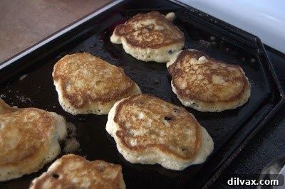 Stack of fluffy lemon blueberry pancakes with syrup