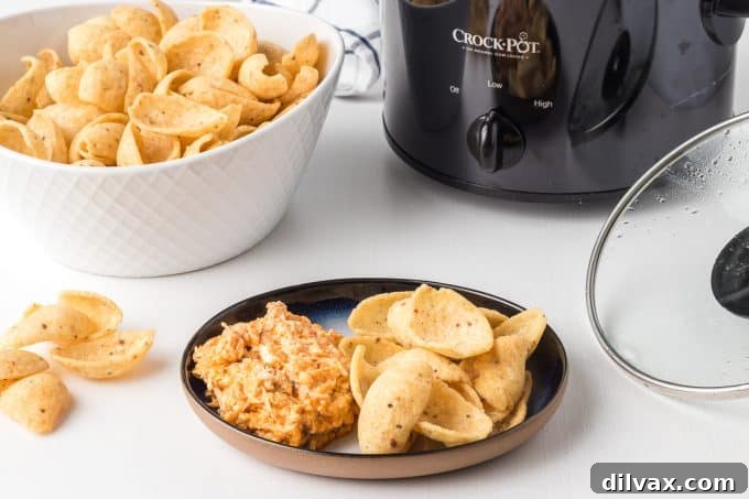 Creamy Slow Cooker Buffalo Chicken Dip, garnished with green onions.