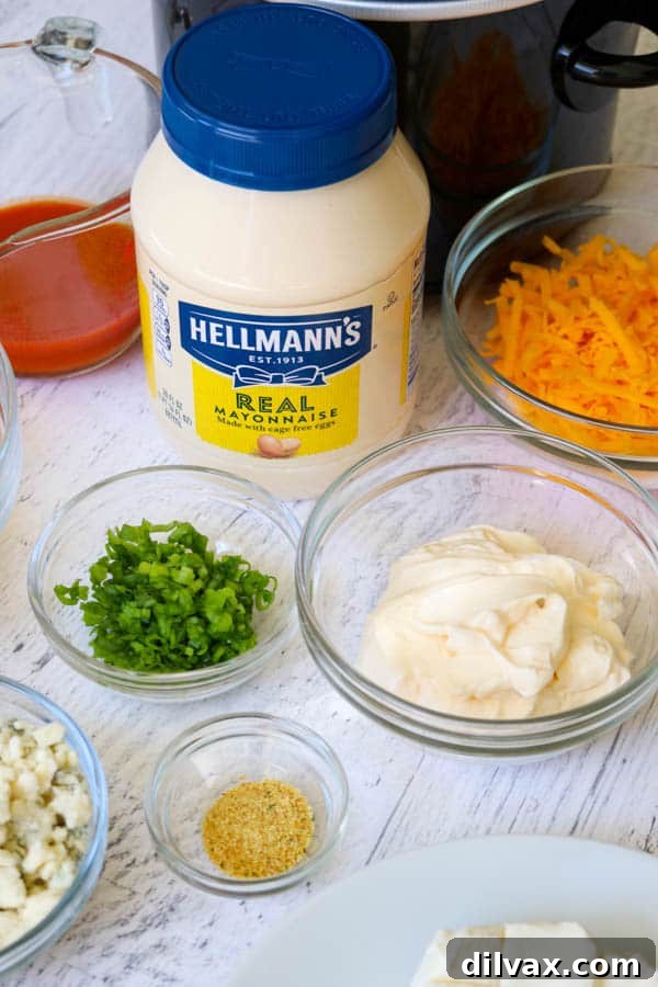 Hellmann's Mayonnaise alongside ingredients for Slow Cooker Buffalo Chicken Dip.