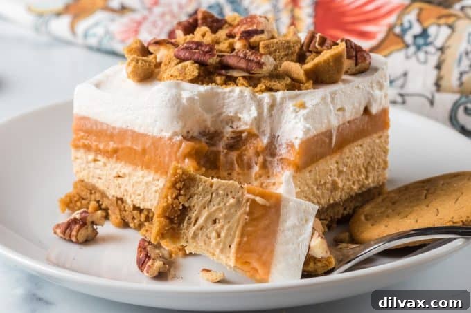 Creamy Pumpkin Dream 2 A perfectly portioned slice of No-Bake Pumpkin Lush, showing the distinct layers and ready to be enjoyed.