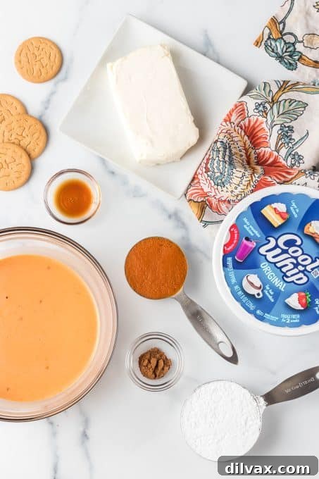 Creamy Pumpkin Dream 4 Essential ingredients laid out for making No-Bake Pumpkin Dream Bars, including cookies, pumpkin puree, cream cheese, and pudding mix.