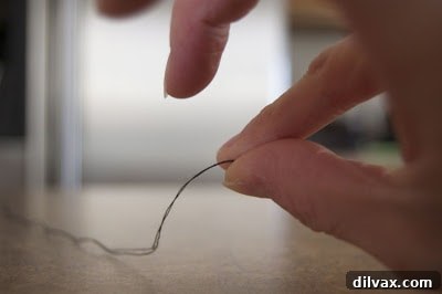 Step 2: Thread wrapped around forefinger twice.