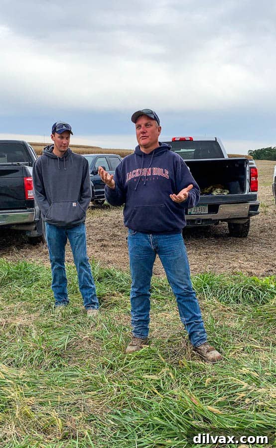 Dedicated Farmer Steve Kuiper with his son on their Iowa corn farm, embodying sustainable practices. Farmer Steve Kuiper and his son stand proudly on their corn farm in Iowa, representing generations of agricultural commitment.