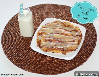 Fluffy cinnamon roll pancakes generously drizzled with sweet cream cheese icing.