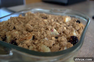 Deliciously baked Blackberry French Toast, golden brown and topped with fresh berries.