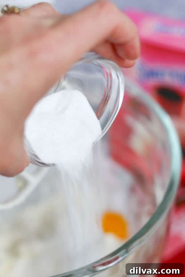 Sweet'N Low® added to Spritz cookie dough. Adding Sweet'N Low® to Spritz Cookie batter.