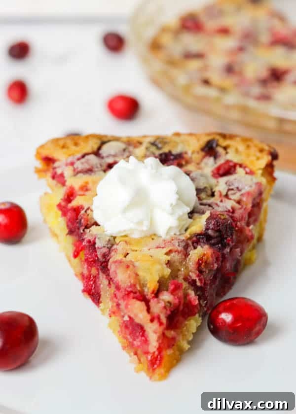 A close-up of a slice of Easy Cranberry Pie Recipe, garnished with whipped cream, highlighting its delicious texture.